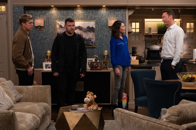 Robert, Aaron, Chas and Liam stand in the pub back room in Emmerdale