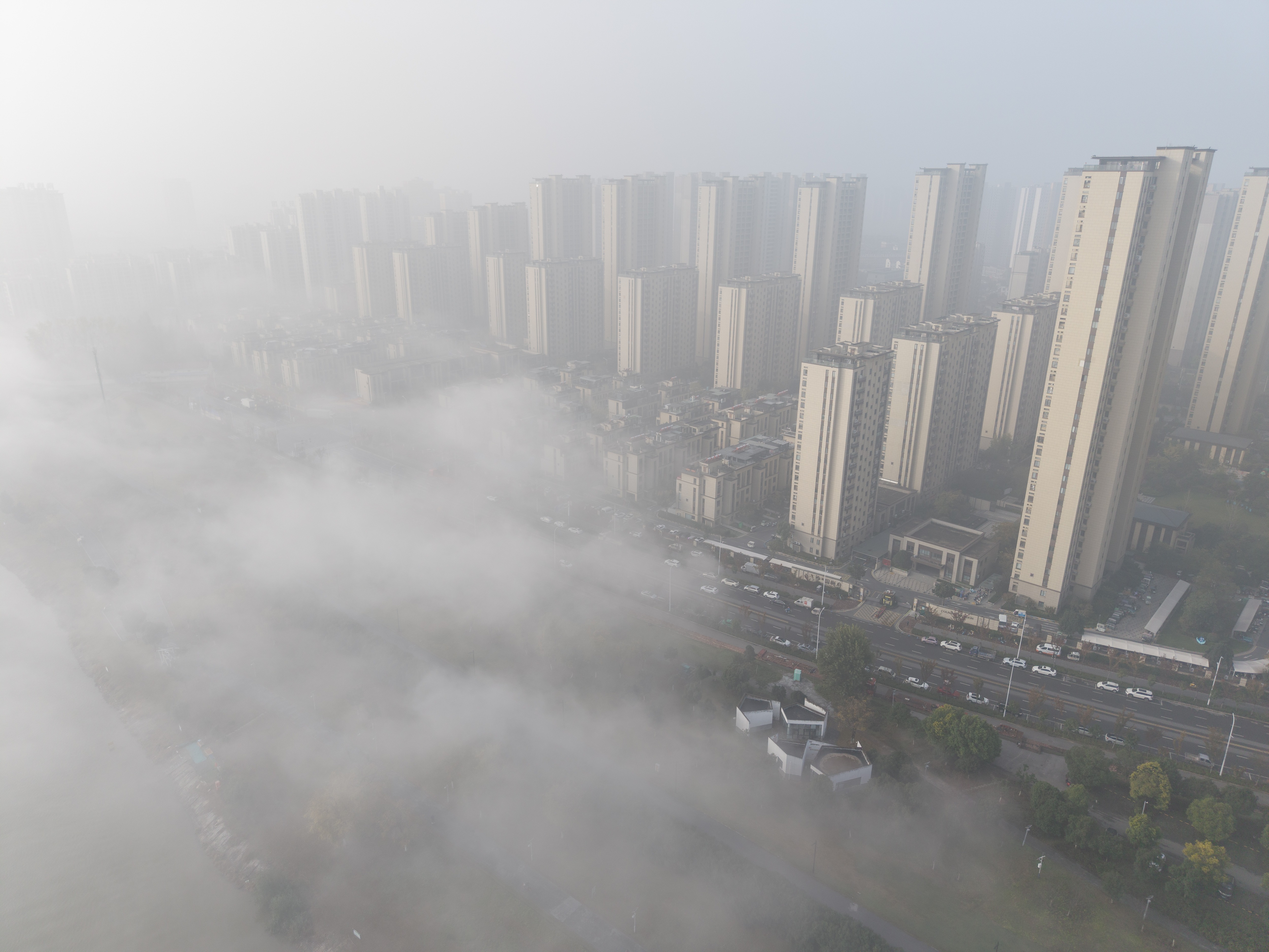 drone view of pollution hanging over skyscrapers of Fuyang, China