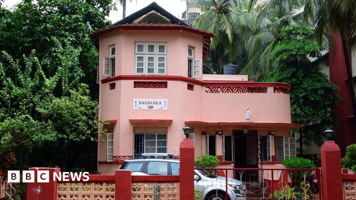 The pink facade of the Saudades art deco-style family bungalow, built in 1936 in Mumbai's Bandra suburb, features local elements like lattice balcony screens.