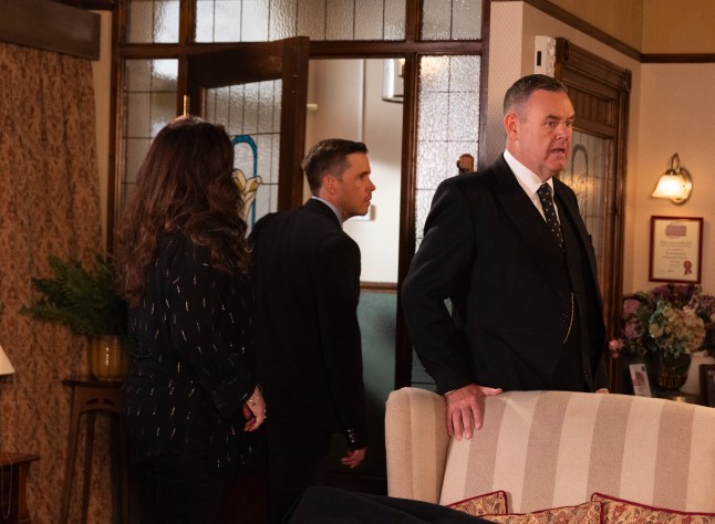 Todd storms out of the funeral parlour in front of George in Corrie