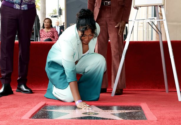 Chadwick's tearful wife Taylor Simone Ledward is pictured looking at the star