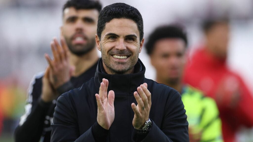 Mikel Arteta applauds on the Arsenal touchline with David Raya and Ethan Nwaneri behind