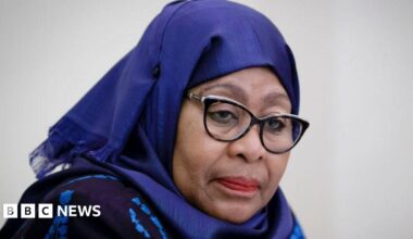 Samia Suluhu Hassan wearing a blue headscarf and glasses