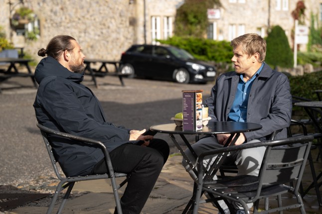 Kev speaks to Robert outside the cafe in Emmerdale