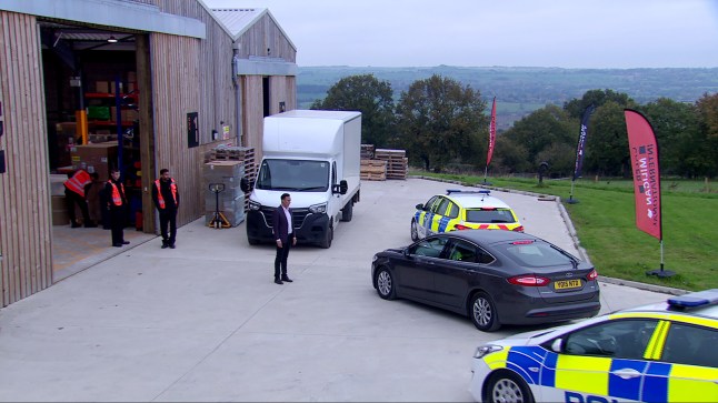 Police cars arrive outside the depot in Emmerdale