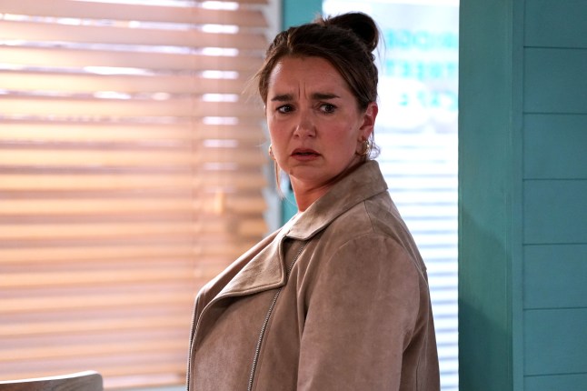 Vicki looks unsure as she enters the cafe in EastEnders