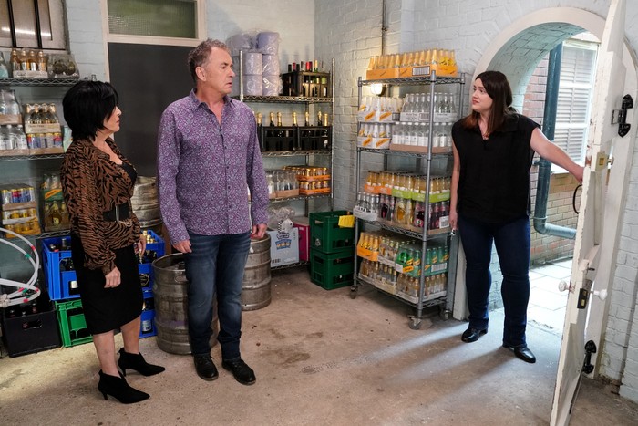 Kat, Alfie and Zoe stand shocked in the barrel store in EastEnders