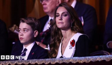 Prince George, Princess Catherine, King Charles and Queen Camilla are pictured sat in the front row of a royal box.