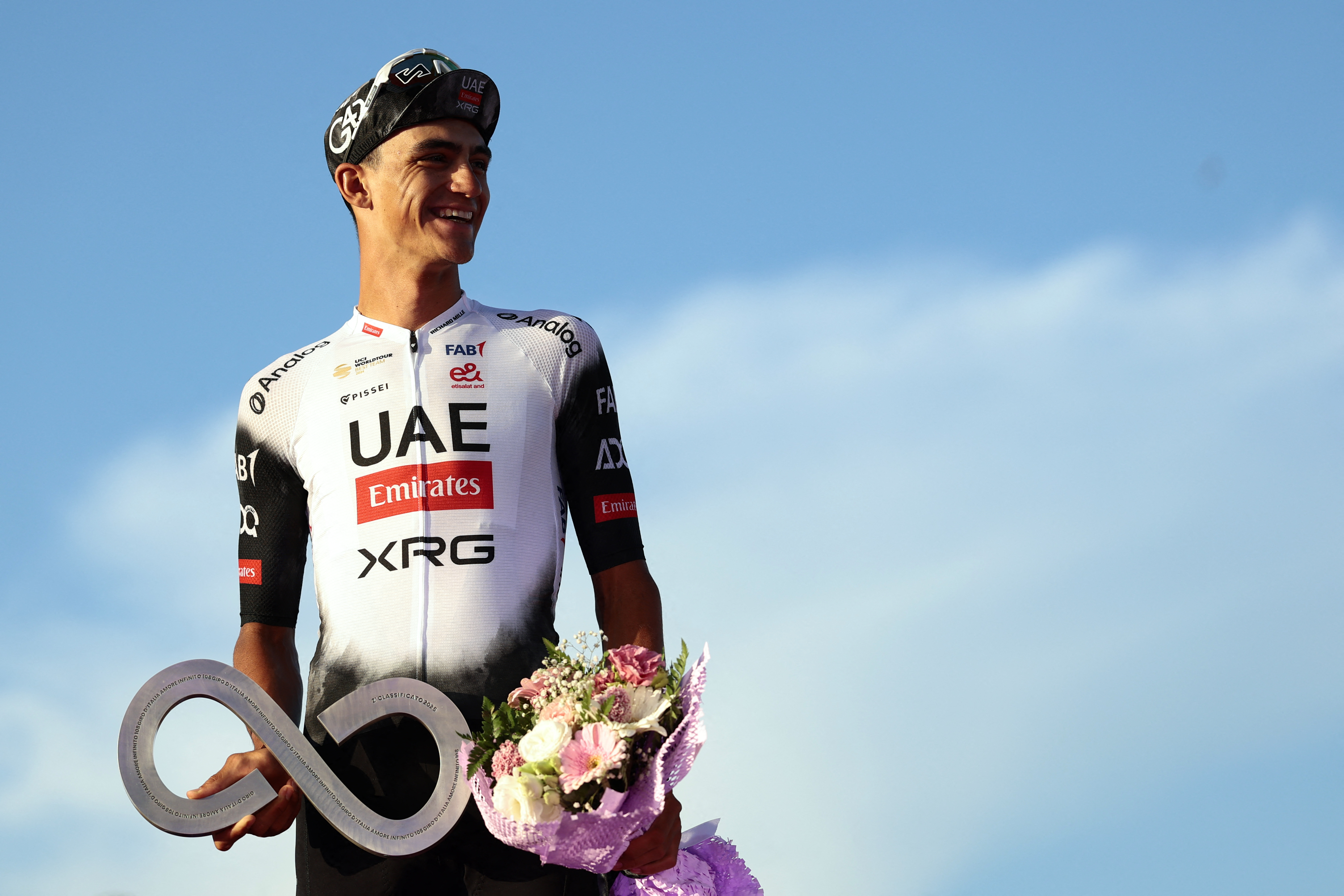 Second placed UAE Team Emirates XRG's Mexican rider Isaac Del Toro celebrates on the podium at the end of the 21st and last stage of the 108th Giro d'Italia cycling race of 143kms from Rome to Rome on June 1, 2025. (Photo by Luca Bettini / AFP)