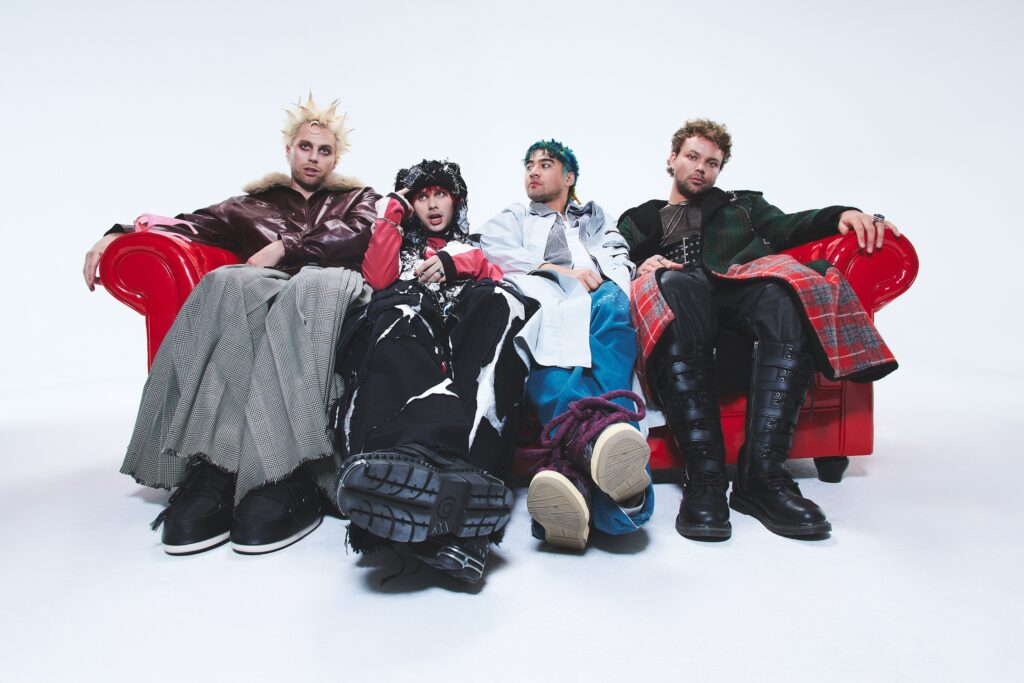Members of 5SOS sit on a couch for promotional imagery of 'Everyone's A Star!'