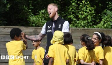 England captain Ben Stokes with some school children