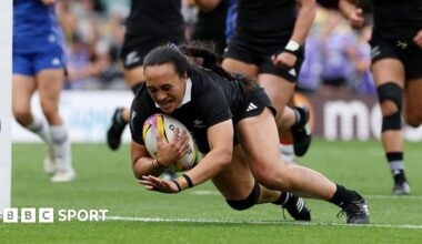 Ruahei Demant dives over the line holding the ball to score a try for New Zealand