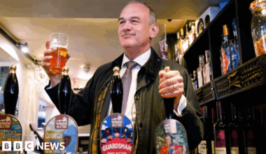 Liberal Democrat leader Ed Davey pulls a pint in a pub
