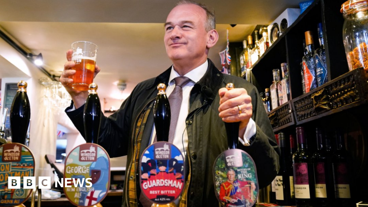 Liberal Democrat leader Ed Davey pulls a pint in a pub
