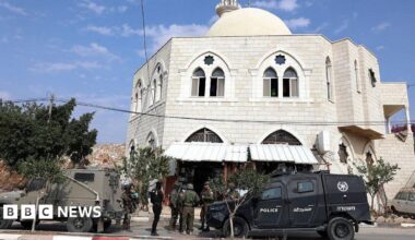 Israeli security forces stand next to their vehicles as they inspect the Hajja Hamida Mosque after it was set on fire and vandalised by Israeli settlers in the Palestinian village of Deir Istiya
