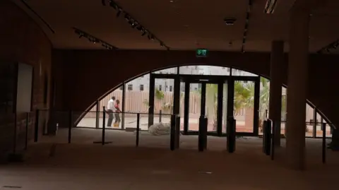 View of workmen seen from inside the new Museum of West African Art