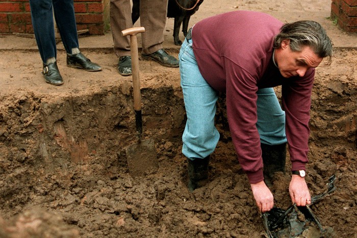 Jimmy and Rosie watch Eddie unearthing Trevor Jordache's body from under the patio in Brookside