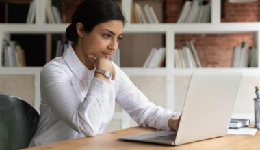 Smart young brown businesswoman working from home on a laptop