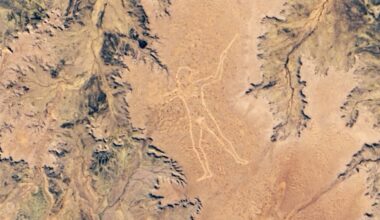 A satellite photo of the Australian outback with a human figure carved into the ground