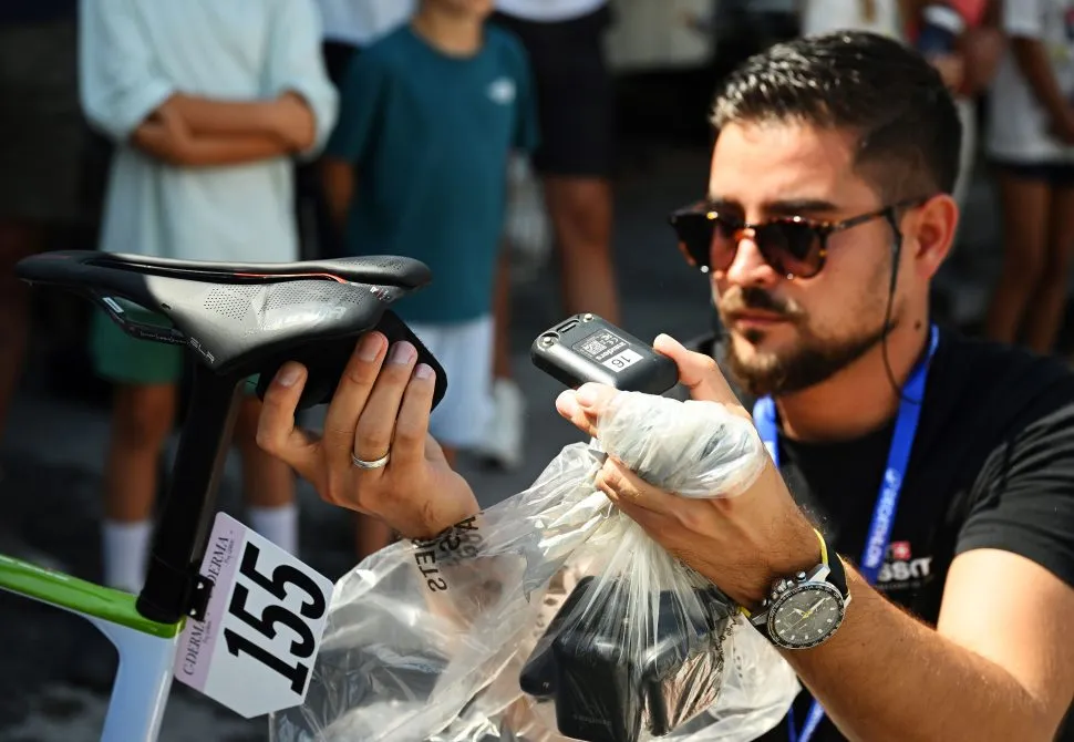 4th Tour de Romandie Feminin 2025 - Stage 2 LA TZOUMAZ, SWITZERLAND - AUGUST 16: A technician from the International Cycling Union (UCI) checks the GPS security tracker during the 4th Tour de Romandie Feminin 2025, Stage 2 a 123.2km stage from Conthey to La Tzoumaz 1522m / #UCIWWT / on August 16, 2025 in La Tzoumaz, Switzerland. (Photo by Dario Belingheri/Getty Images)