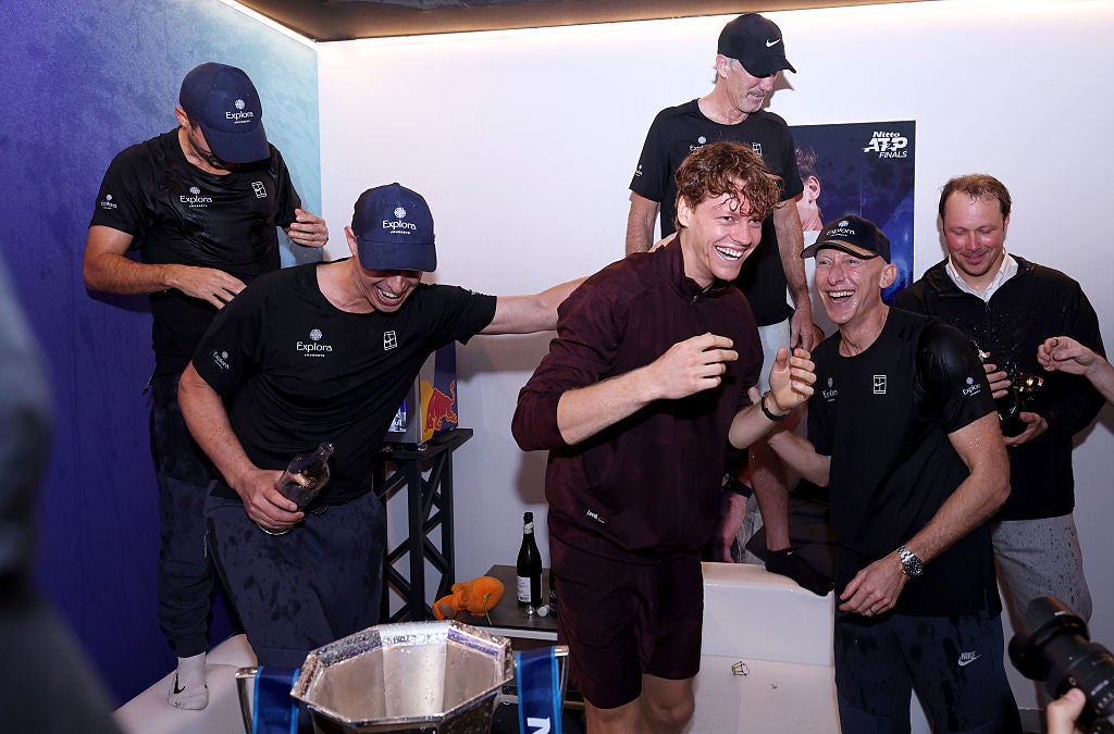 Jannik Sinner celebrates in the locker room with champagne and his team