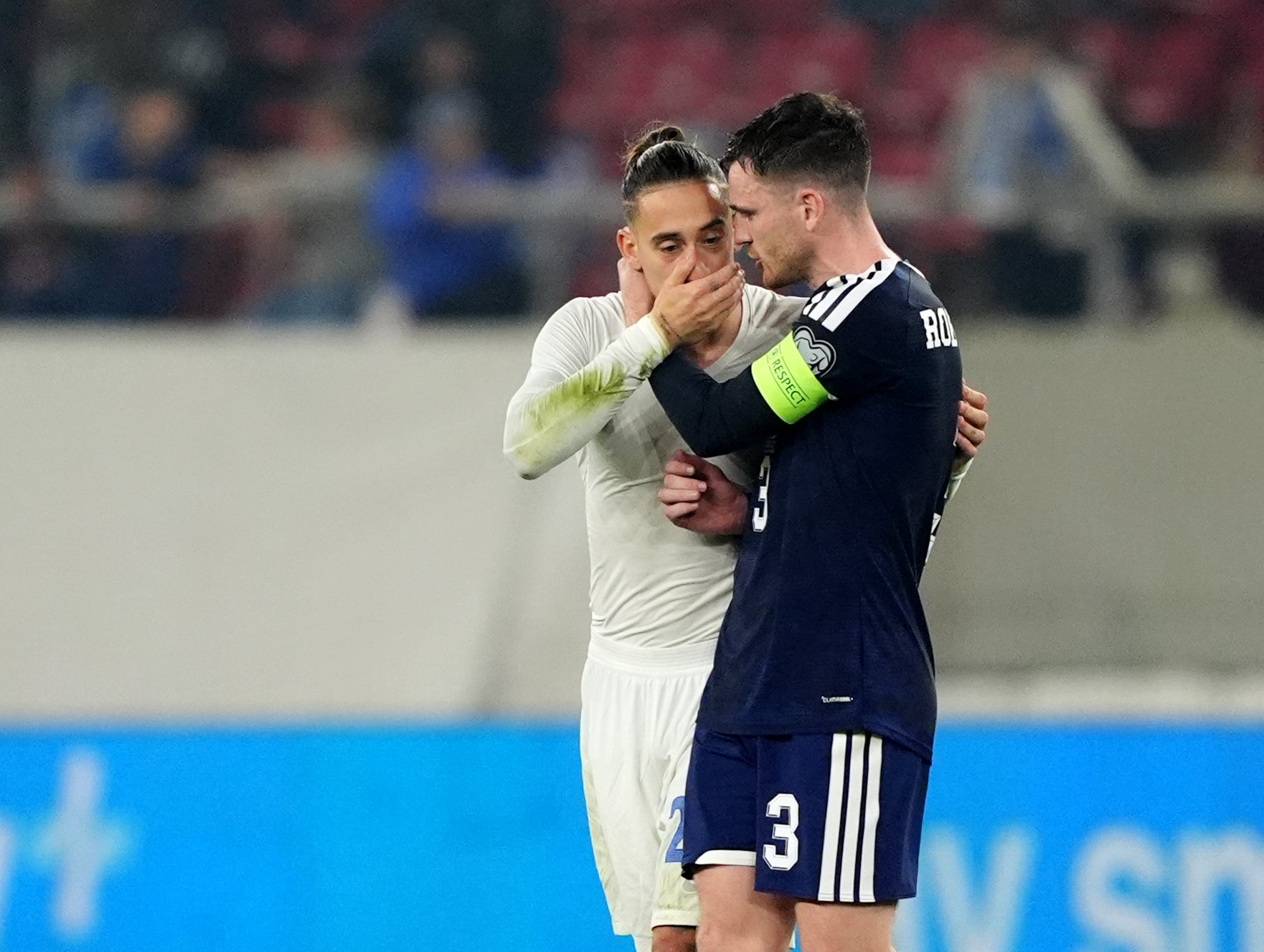 Andy Robertson embraces ex-Liverpool teammate Kostas Tsimikas after the game
