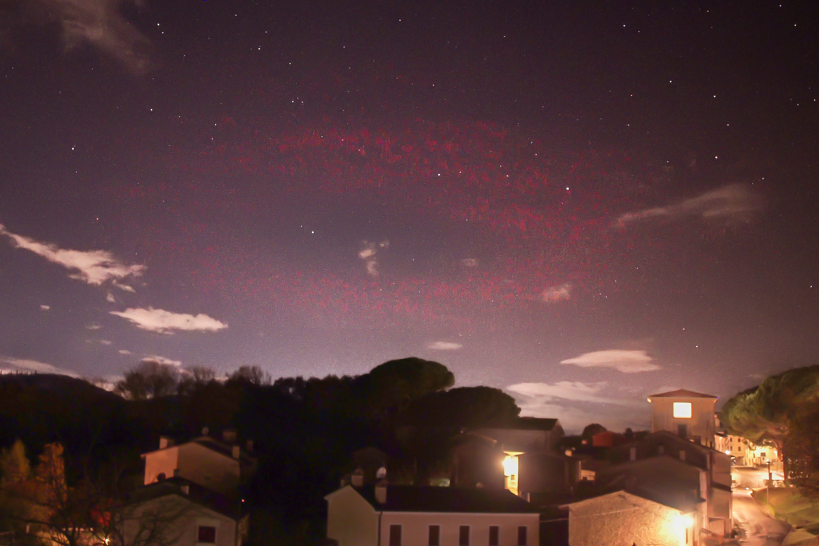 a red halo appears as an eerie symbol in the night sky.