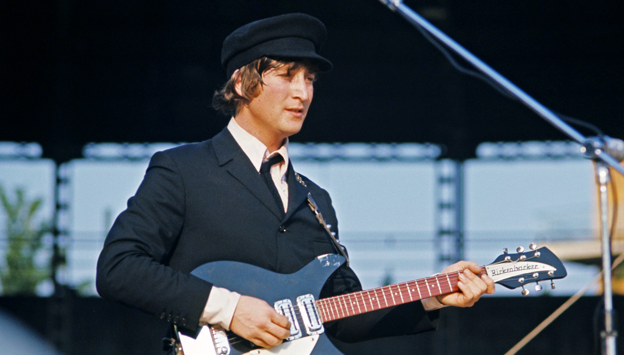British singer, composer and musician John Lennon (John Winston Ono Lennon) playing guitar and singing during the concert of British band The Beatles at the Velodromo Vigorelli. Milan, 24th June 1965.