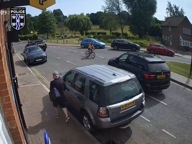 A CCTV screengrab showing the moment an SUV cuts into a cyclist.