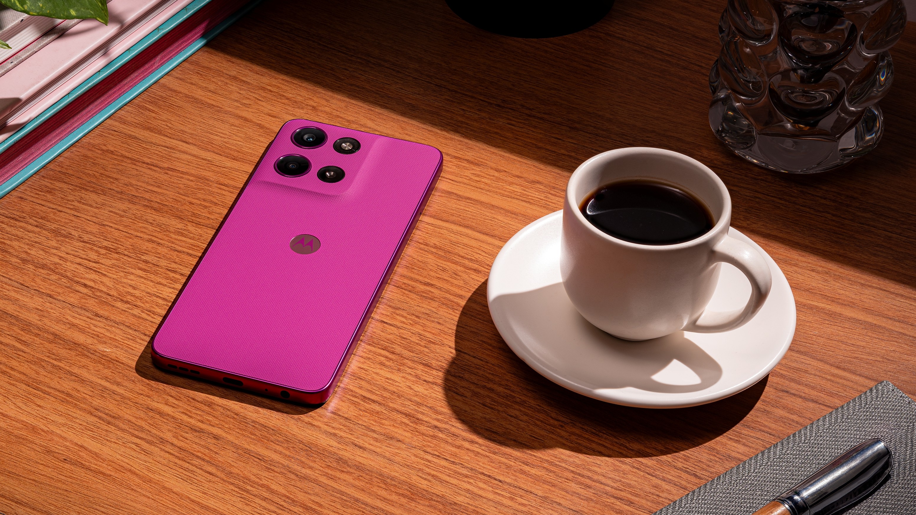 Moto G 2026 on a table next to a cup of coffee