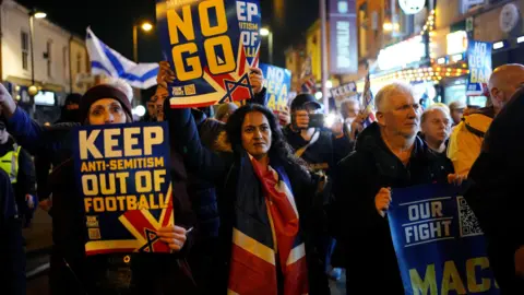 Reuters Pro Israel supporters are led to Villa Park, home of Aston Villa by police officers, before the UEFA Europa League match at Villa Park, Birmingham