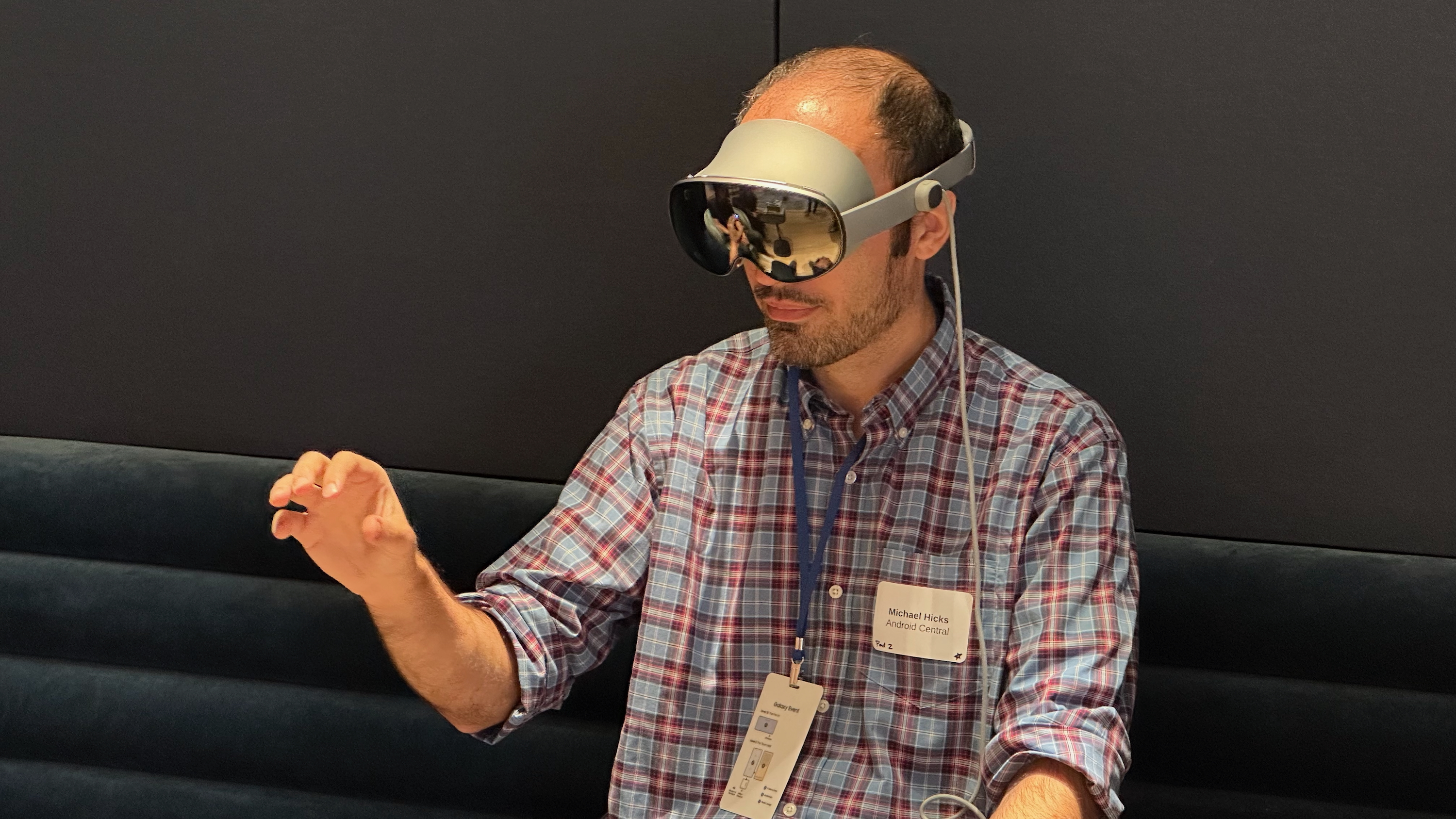 A photo of the author wearing the Samsung Galaxy XR headset, holding up one hand in a pinch gesture.