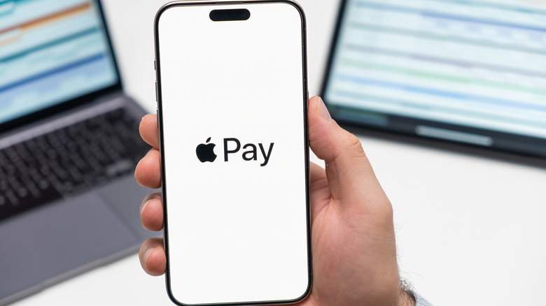 Apple Pay logo visible on iPhone.
