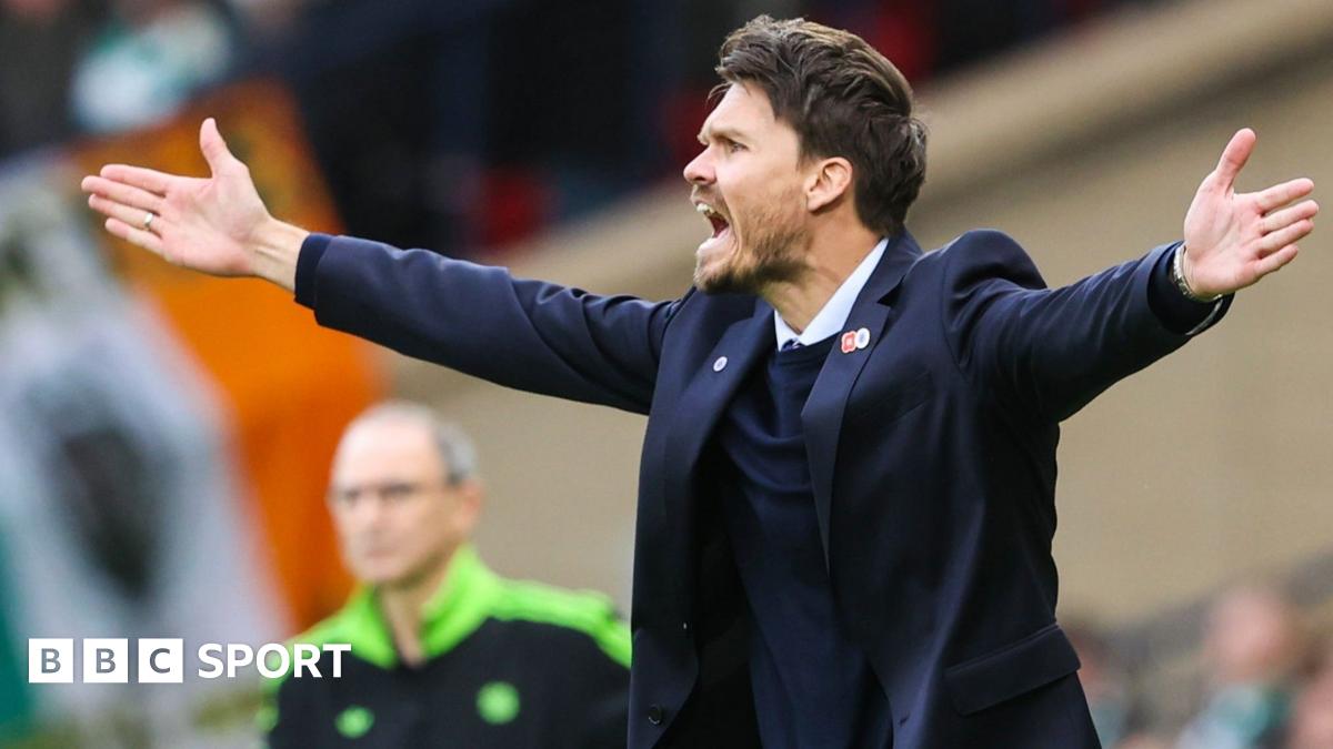 Referee Nick Walsh shows Celtic's Auston Trusty a yellow card