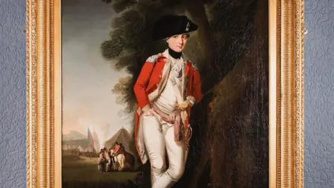 MNH An oil painting of Paul Crebbin. He is wearing a red greatcoat and white uniform underneath, with a black hat on his head. There is a tent in the background and two people on a horse speaking to others on foot.