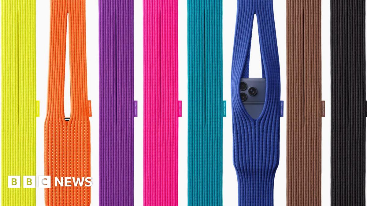 A display of eight brightly coloured knitted iPhone Pocket bags, two with iPhones in them, coloured from the left yellow, orange, purple, pink, turquoise, blue, brown and black.