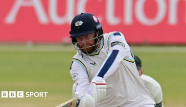 Jonny Bairstow, wearing a Yorkshire helmet, attempting a shot into the legside to a spinner, with the wicketkeeper stood behind the stumps
