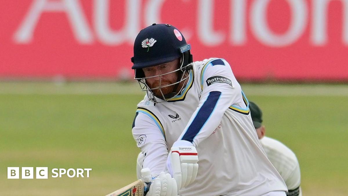 Jonny Bairstow, wearing a Yorkshire helmet, attempting a shot into the legside to a spinner, with the wicketkeeper stood behind the stumps