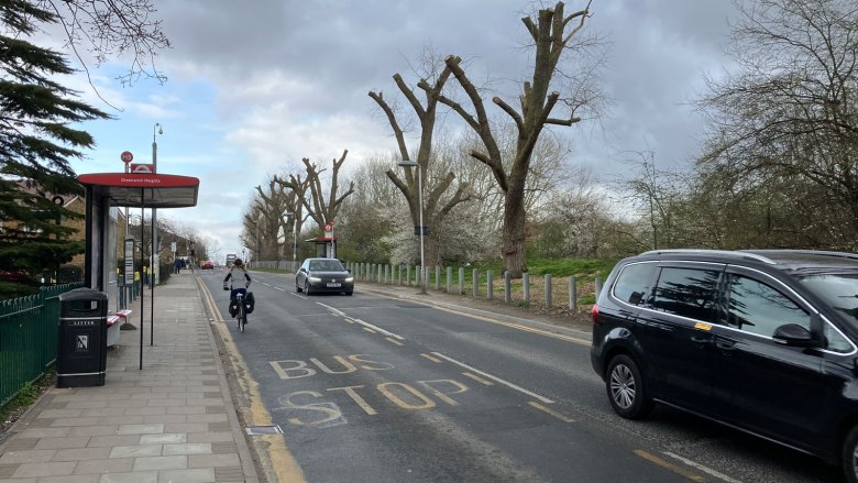 Road with traffic on and a cyclist