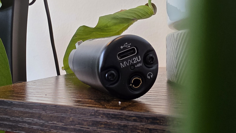 Shure MVX2U audio interface on a table with plants