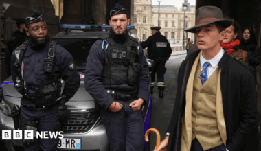 Close up photo of ornate pearl and diamond tiara worn by Empress Eugenie as displayed at the Louvre Museum, Paris