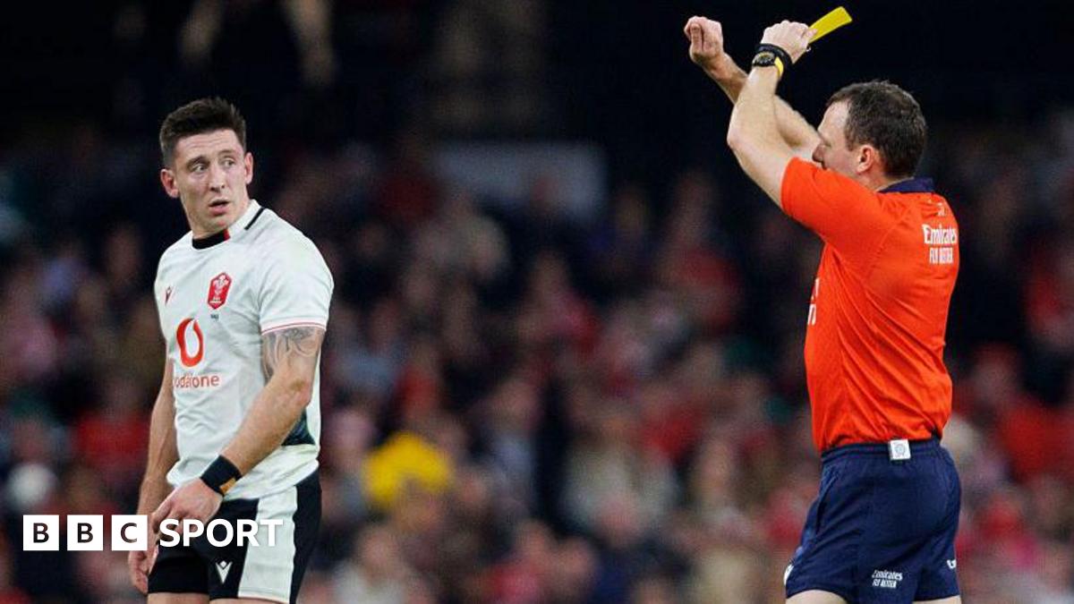 Josh Adams is shown a yellow card by English referee Matthew Carley