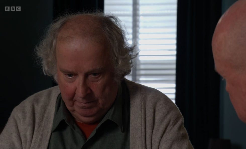 eastenders, nigel bates and phil mitchell sitting down with nigel looking sad