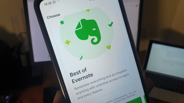 Person holding a phone with Evernote app open
