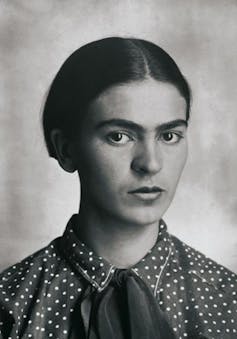 a young Frida Kahlo with hair smoothed back in a centre parting