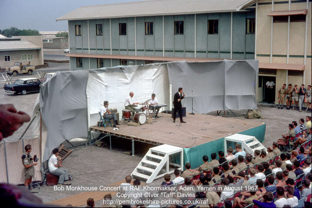 A long shot of Bob Monkhouse in concert at Aden