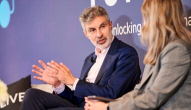 Yoshua Bengio gestures while speaking to a woman during a discussion at the FT AI summit.