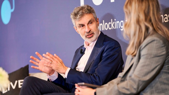 Yoshua Bengio gestures while speaking to a woman during a discussion at the FT AI summit.