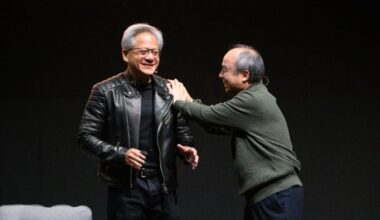Jensen Huang and Masayoshi Son share a lighthearted moment on stage during the Nvidia AI Summit Japan fireside chat.