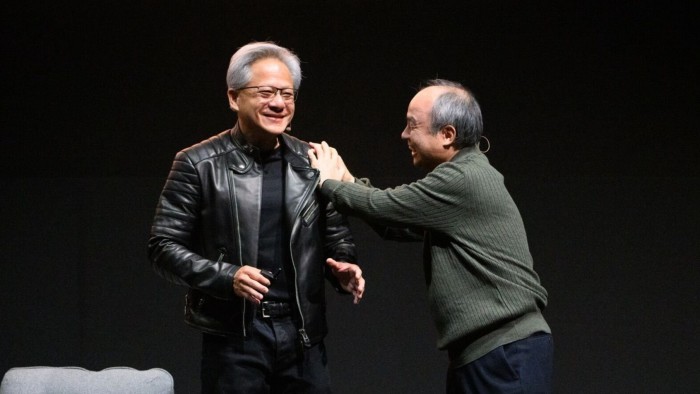 Jensen Huang and Masayoshi Son share a lighthearted moment on stage during the Nvidia AI Summit Japan fireside chat.